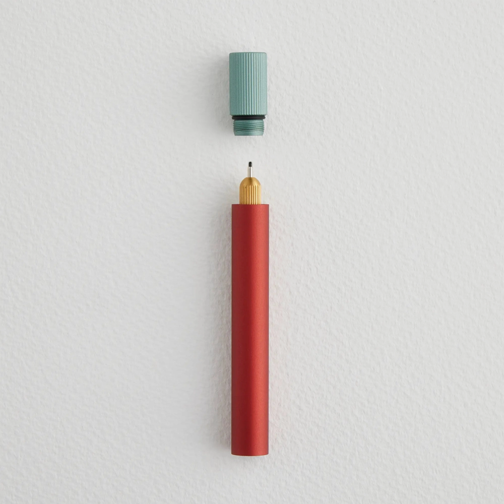 Red pen with a blue cap on a light gray background