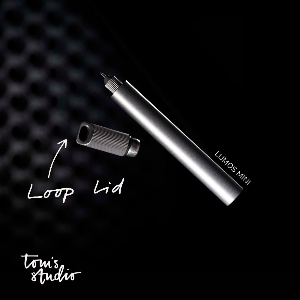 Lumos Mini device with loop lid on a black background, featuring 'Tom's Studio' branding.