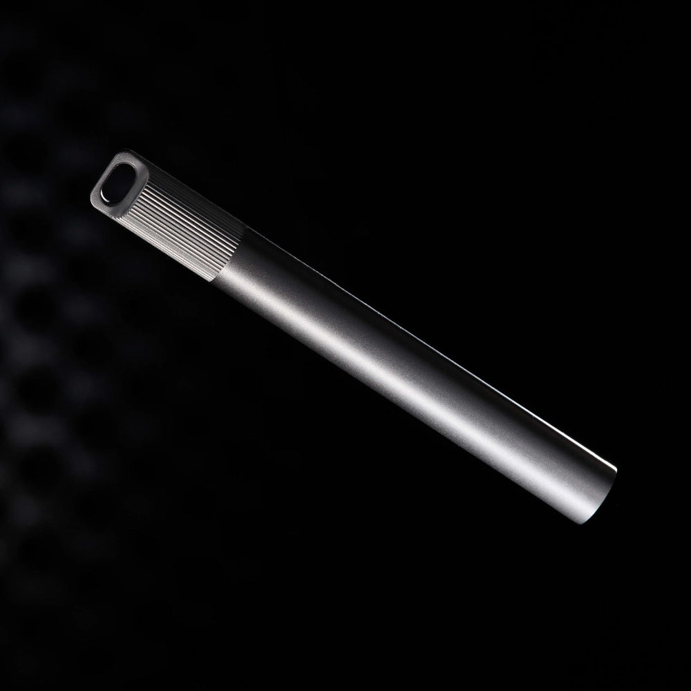 Titanium pen on a black textured background