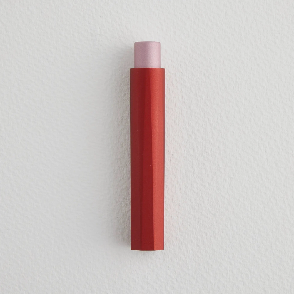Capped pen with a peek of pink coming out of the top and a red body with ridges.