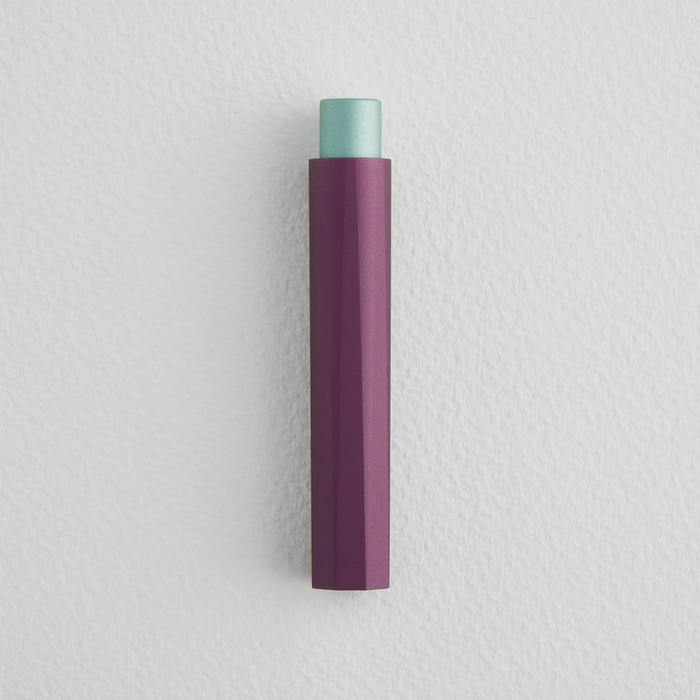 Capped pen with a peek of light blue coming out of the top and a purple body with ridges.