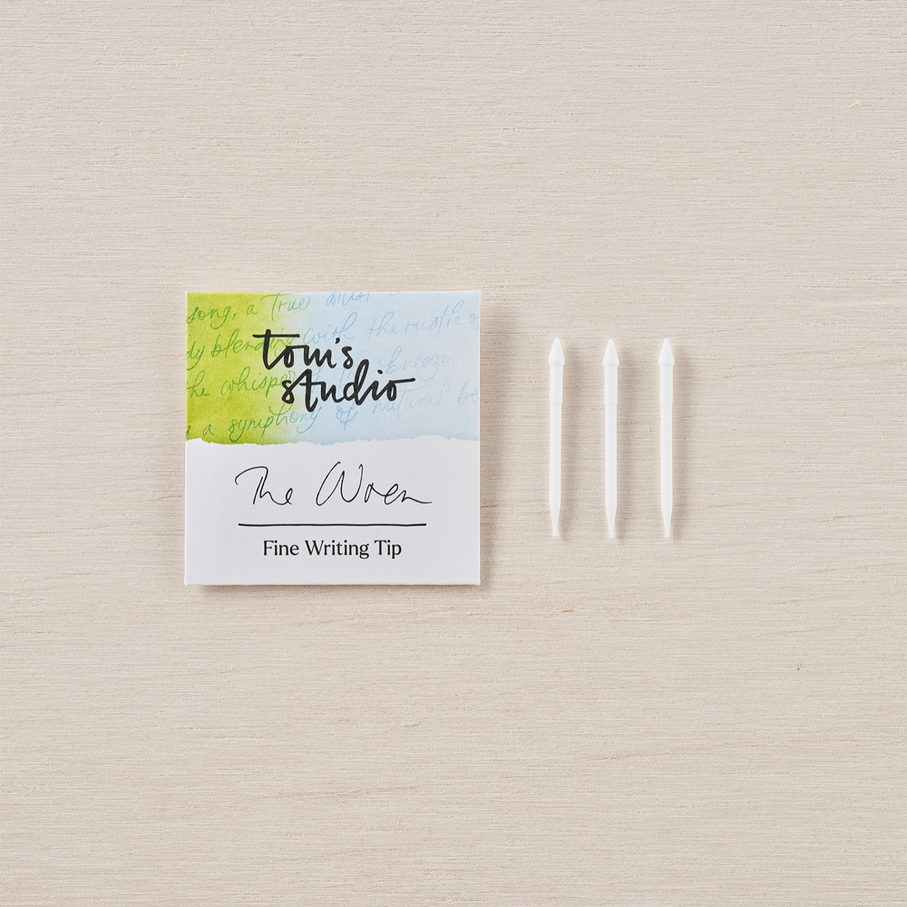 A pack of The Wren writing tips next to three tips on a desk background.