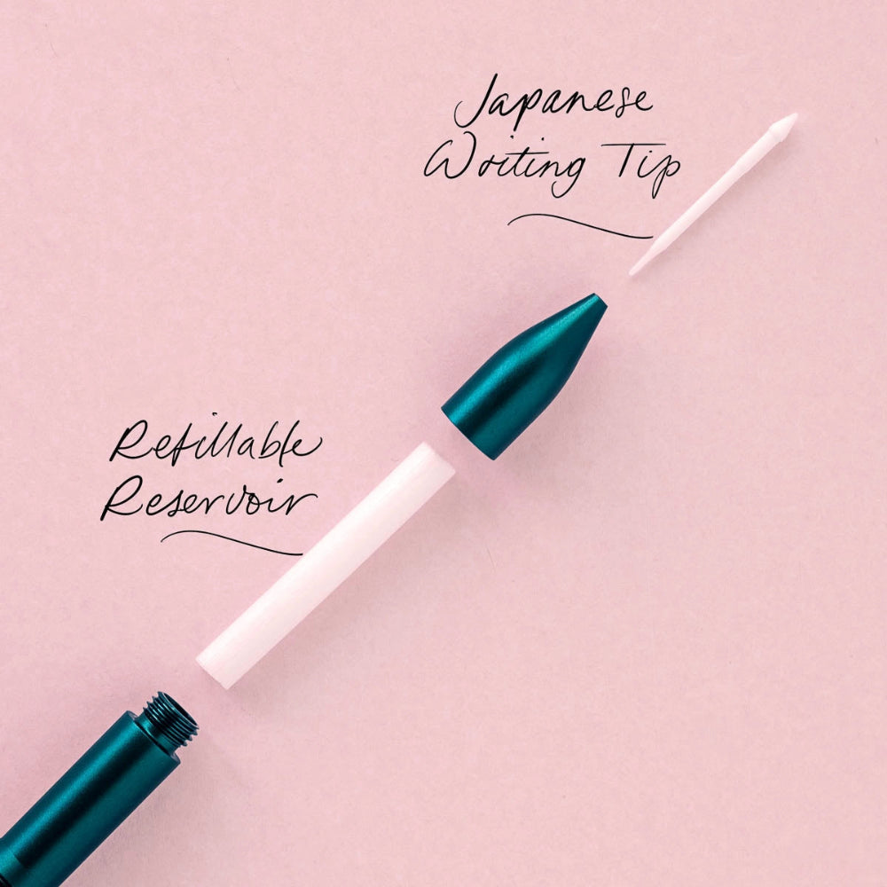 Teal pen with white refill on a pink background, highlighting 'Japanese Writing Tip' and 'Refillable Reservoir'.