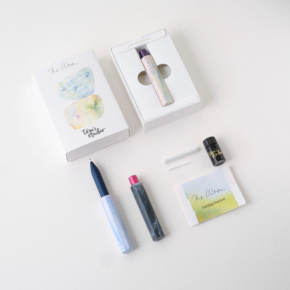 Set of pens products the parts of the pen including a mini bottle of ink