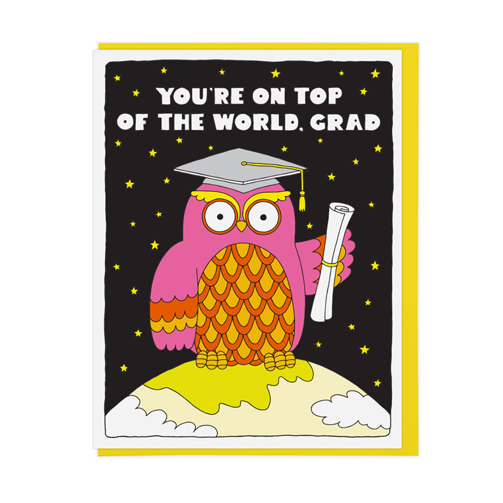 Graduation-themed card with a colorful owl in space on the Earth holding a diploma on a black background with stars. Text reads, "You're on top of the world, grad"