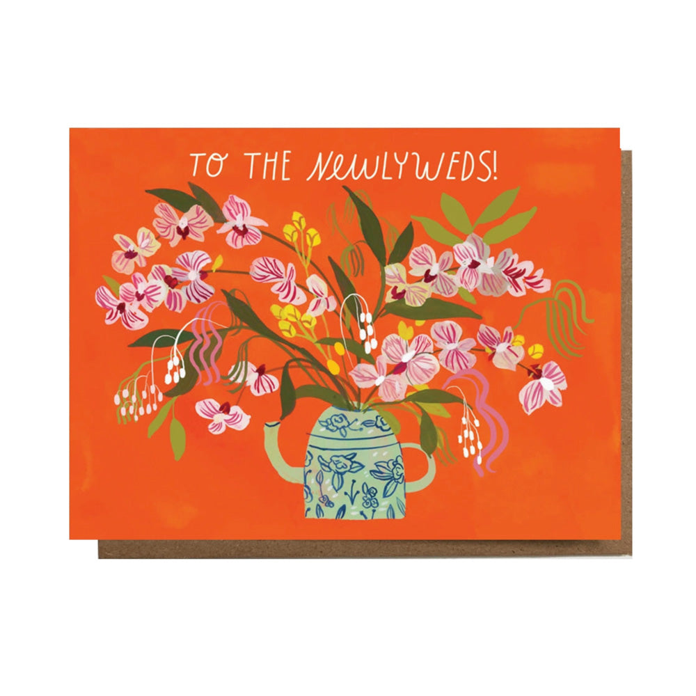 Greeting card with floral design and 'To the Newlyweds!' text on an orange background