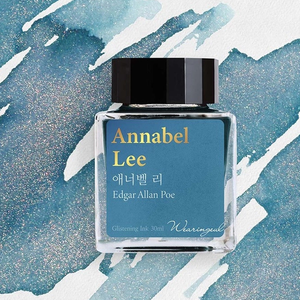 Ink bottle labeled 'Annabel Lee' by Edgar Allan Poe on a blue and white abstract background
